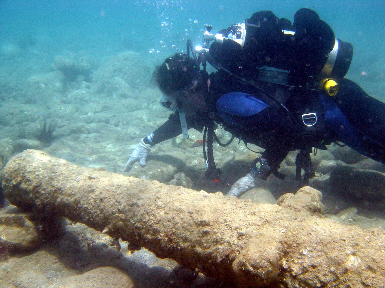 Louis besides one of the cannons, watching out for those sneaky sea urchins