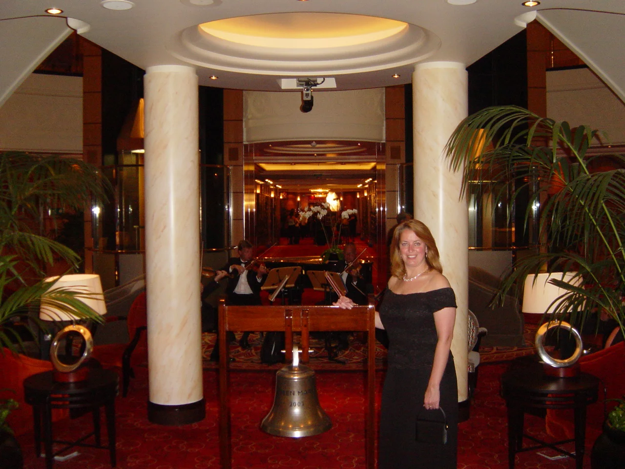 Kathy in front of the Queen Mary 2 ships bell