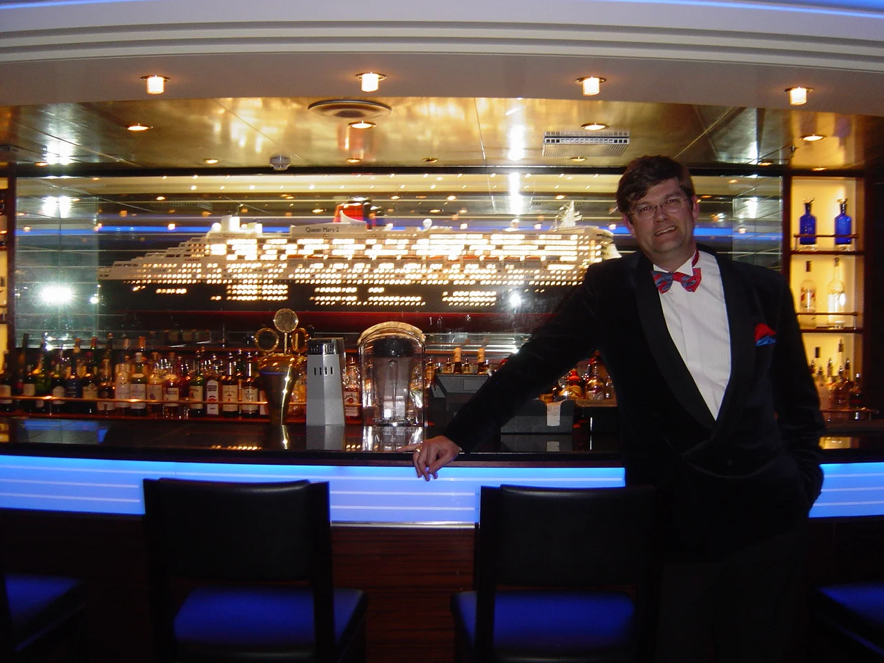 Dr Spooner in the Commodore Club, in front of the scale model of the ship