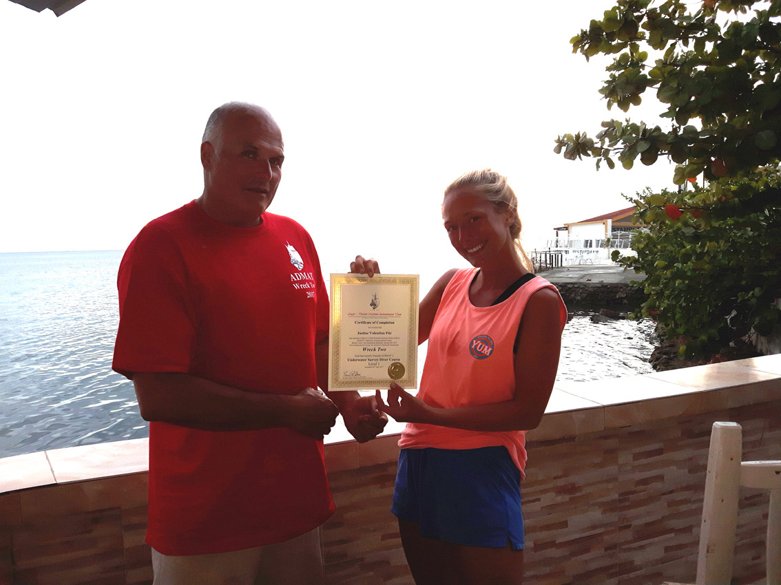Project Leader Raimund Krob in 2017 presenting Justine Fite with her ADMAT's Underwater Survey Diver Course a PADI SDC certification