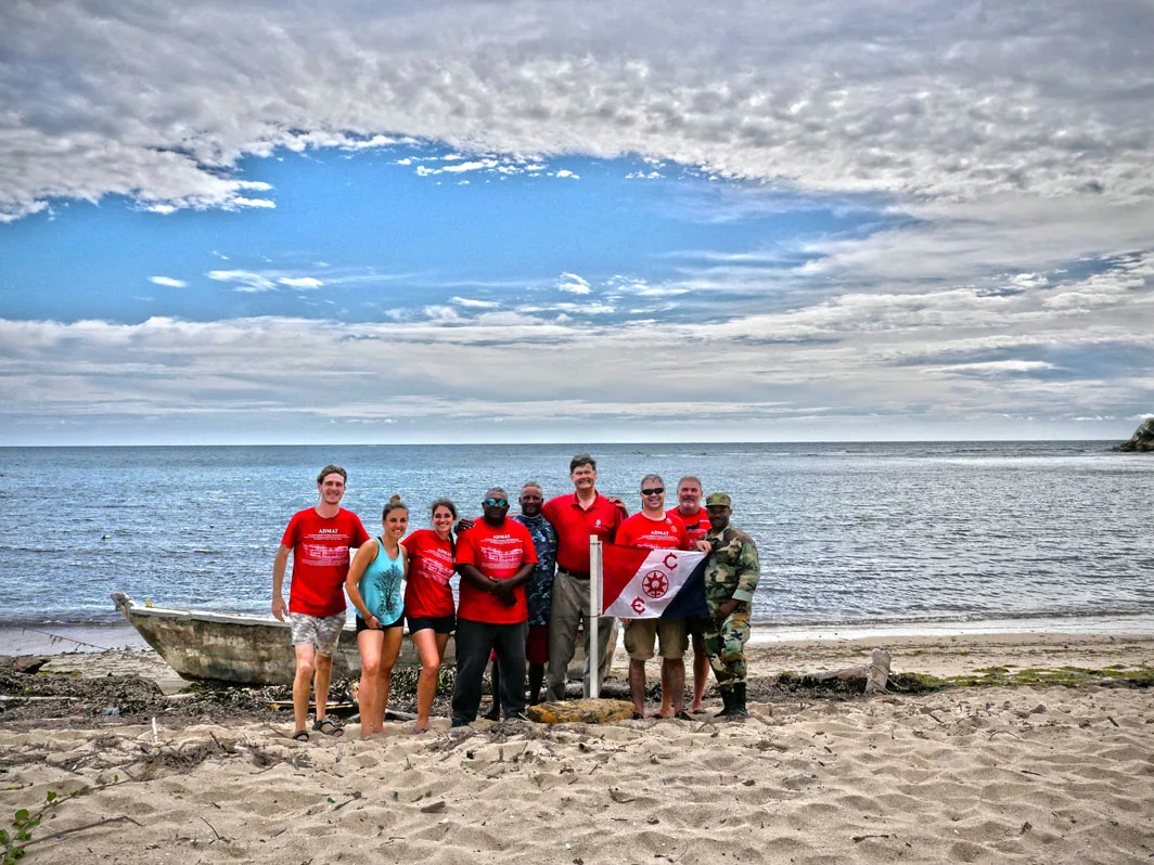 Some of the July 2018 ADMAT survey Team on the beach in front of Le Dragon wreck site