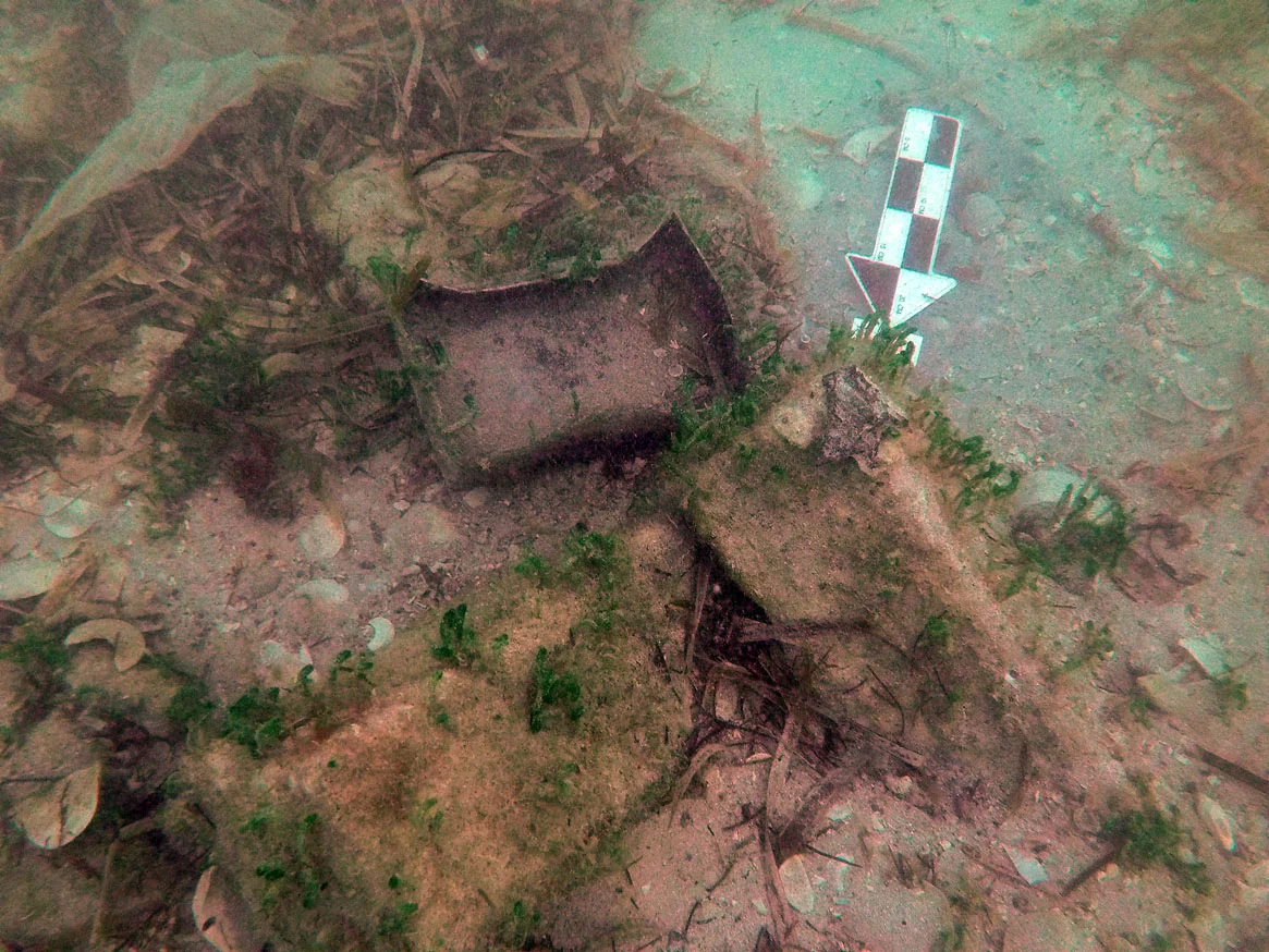 A lead box and lid amongst iron ballast blocks in the stern section of Le Dragon