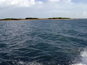 The Aquasport passing one of the Seven Brother Islands in Monte Cristi Bay