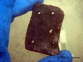 A small lead patch with square nail holes