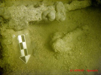 The wrought breach loading swivel cannon next to a lashing pin
