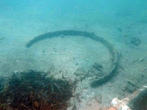 The broken iron barrel hoop which matched the breaks on the remaining iron hoop on the barrel