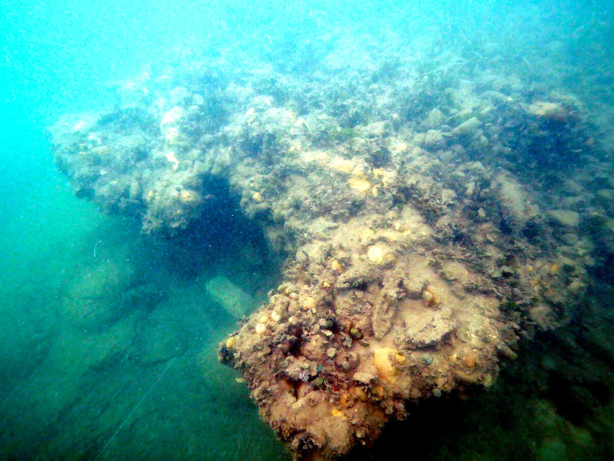 The amidship break in the hull where the main mast would have been. The square cut out section is where te shot locker was before the explosion ripped the ship apart.
