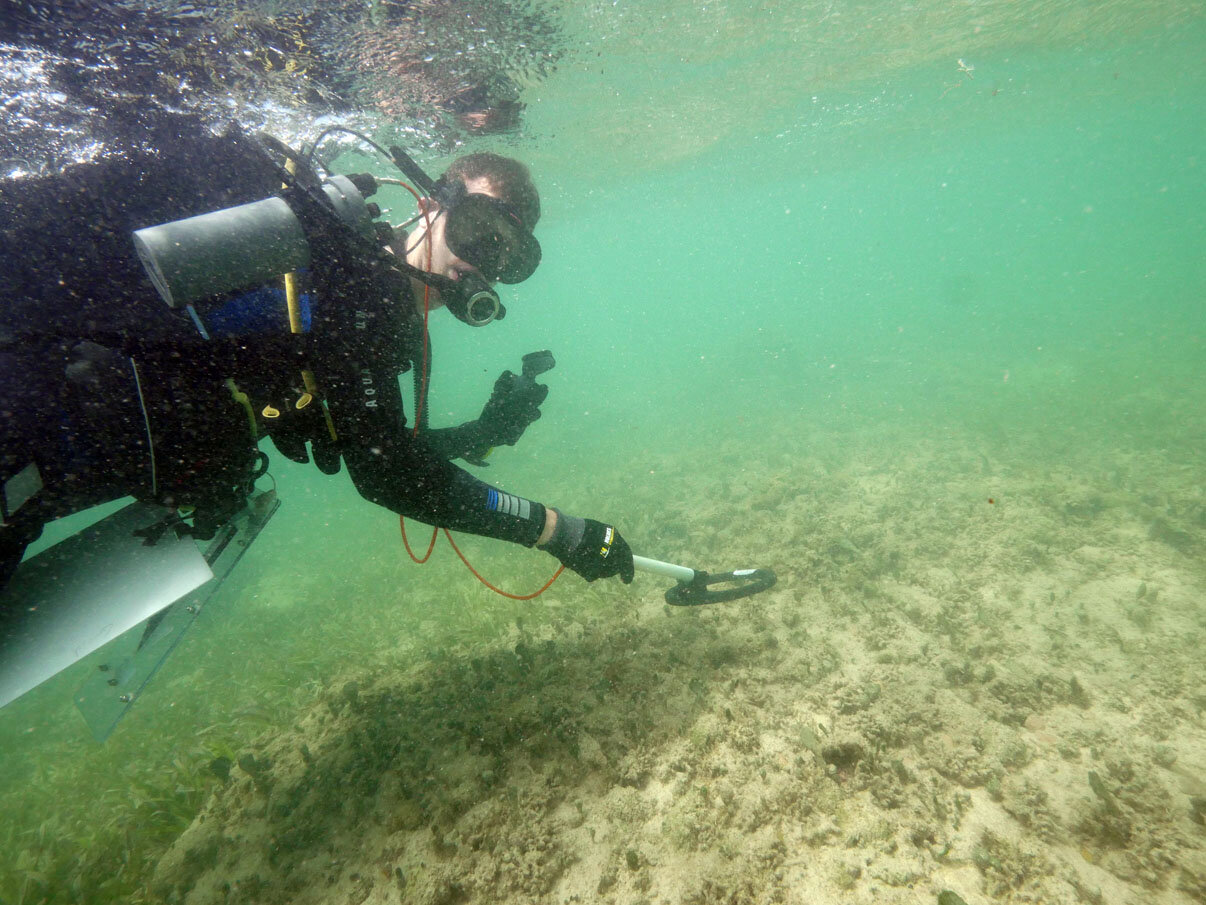 Connor conducting a geophysical survey with an Aquascan Aquapulse metal detector.
