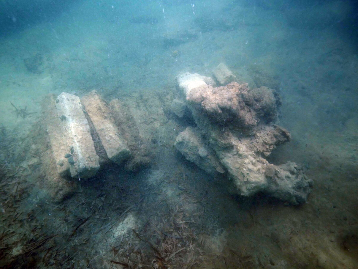 The iron ballast bars, which were measured into the survey grid and then removed, stacked in the amidship break area on top of the long concreted ion bars.