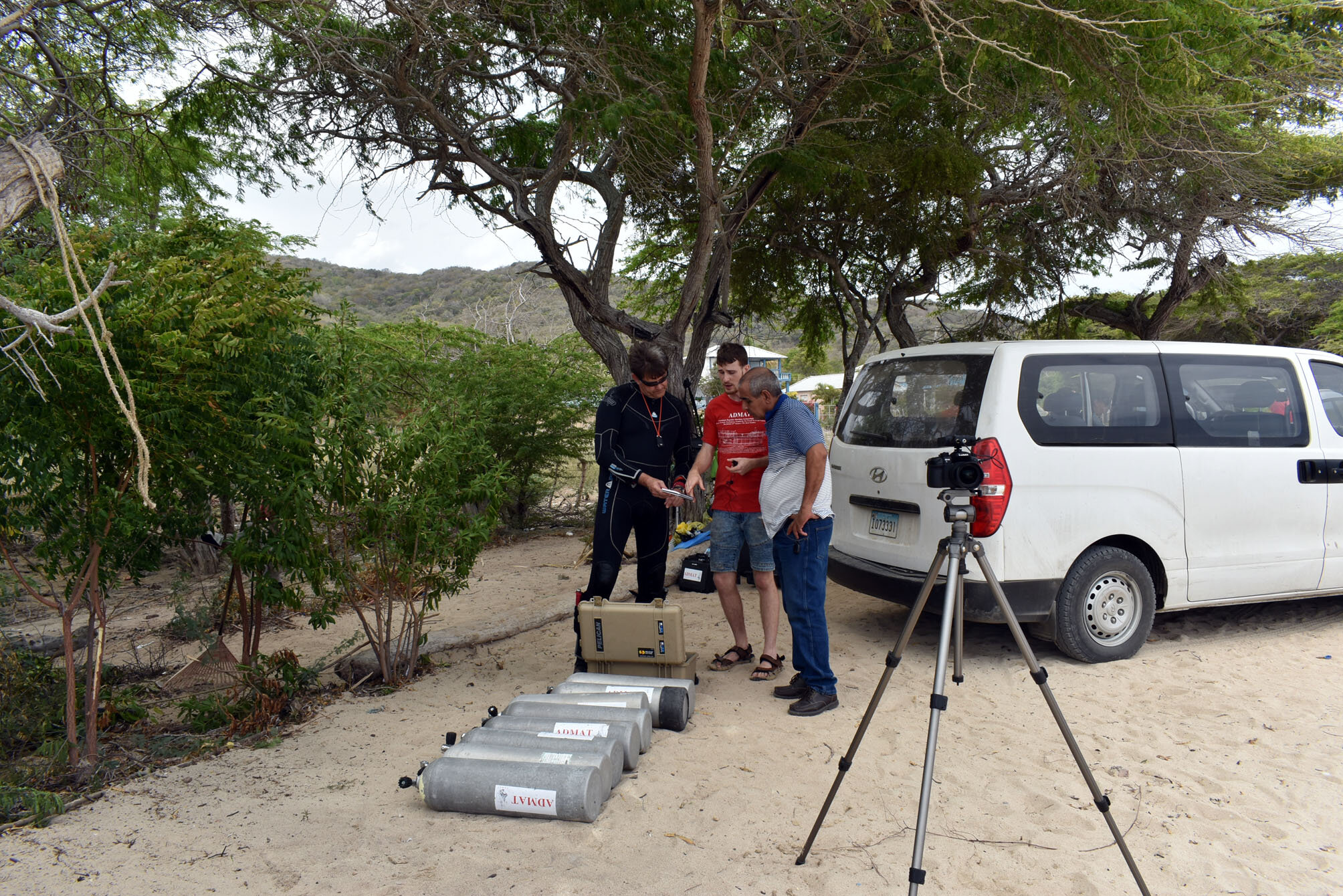 Dr Spooner checking Connor Grzesiak’s underwater drawings with Director Francis Soto watching.