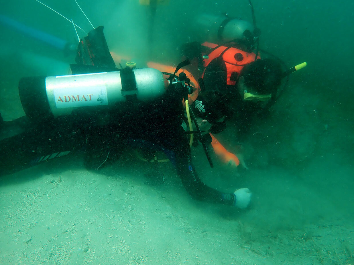 The team uses the archaeological water dredge to uncover the sand on a gradiometer target to find out what it is. The target had a high enough reading to be a small cannon.