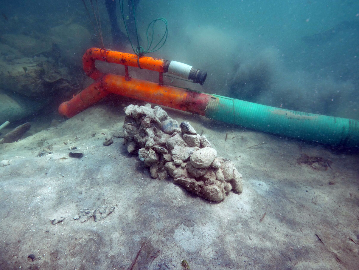 Bob Yee locates another iron ballast bar concreted with ballast stones which is recorded and then removed and placed with the other iron ballast, to clear the area of magnetic signatures.