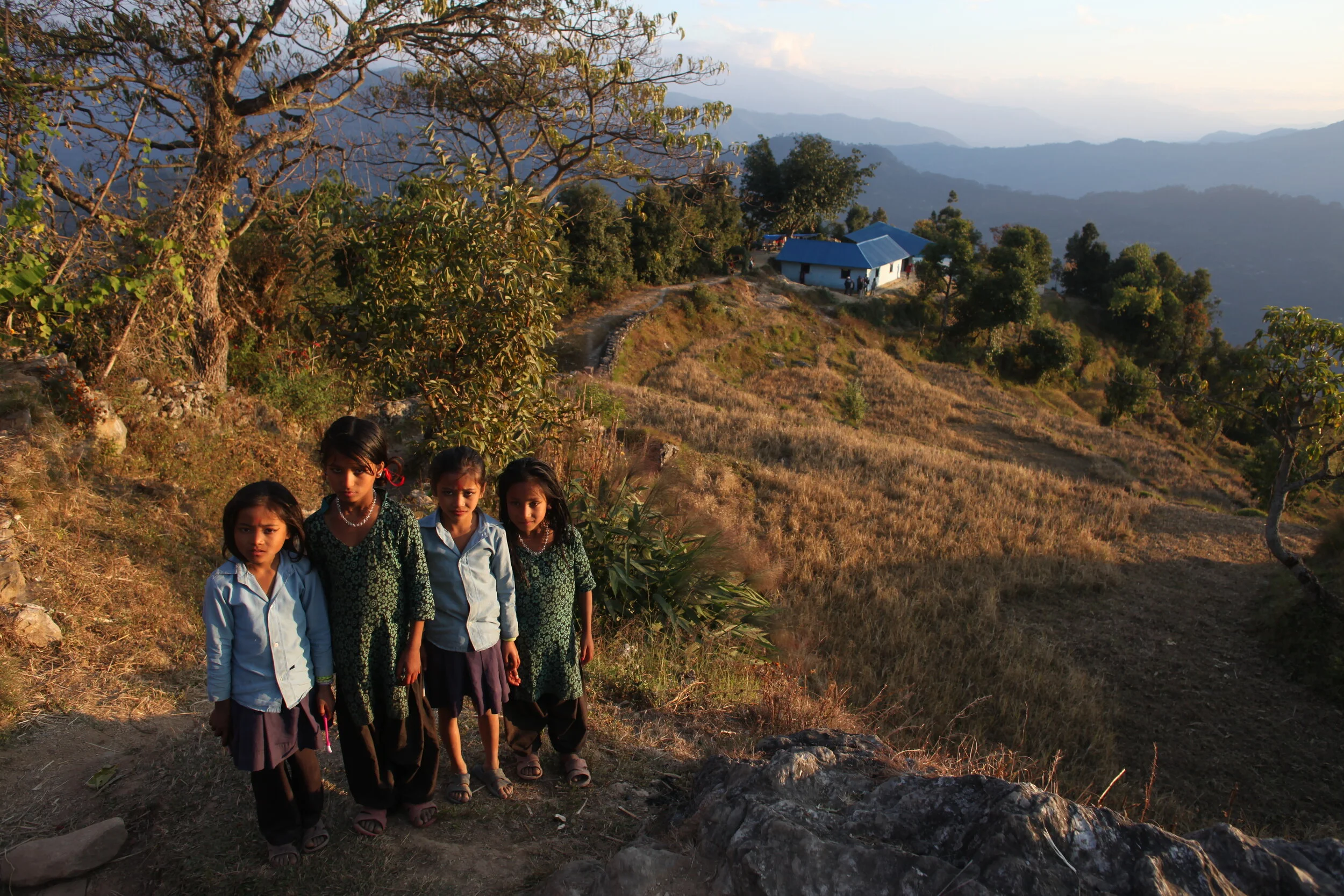 children after the opening and the school in the background.JPG