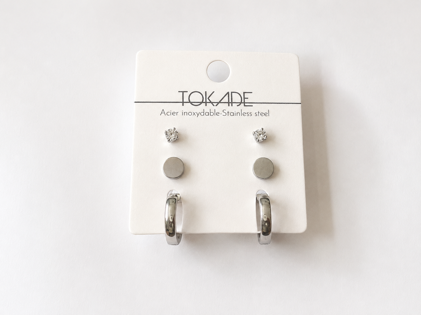 Trio Alina de trois paires de boucles d’oreilles argentées en acier inoxydable avec brillants, boutons ronds et anneaux