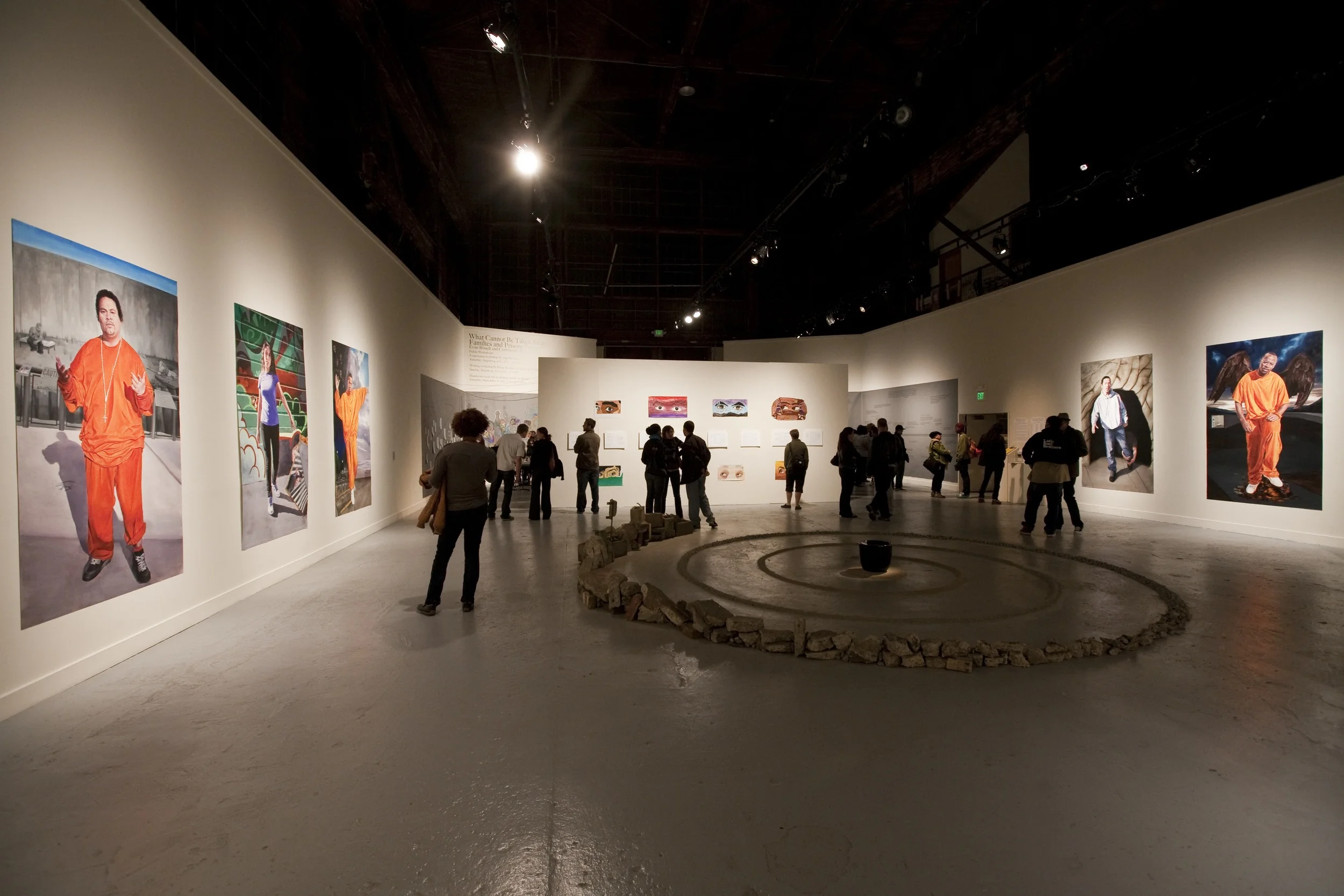 Installation view, including the meditation labyrinth, the eyes paintings by project members and the portraits.