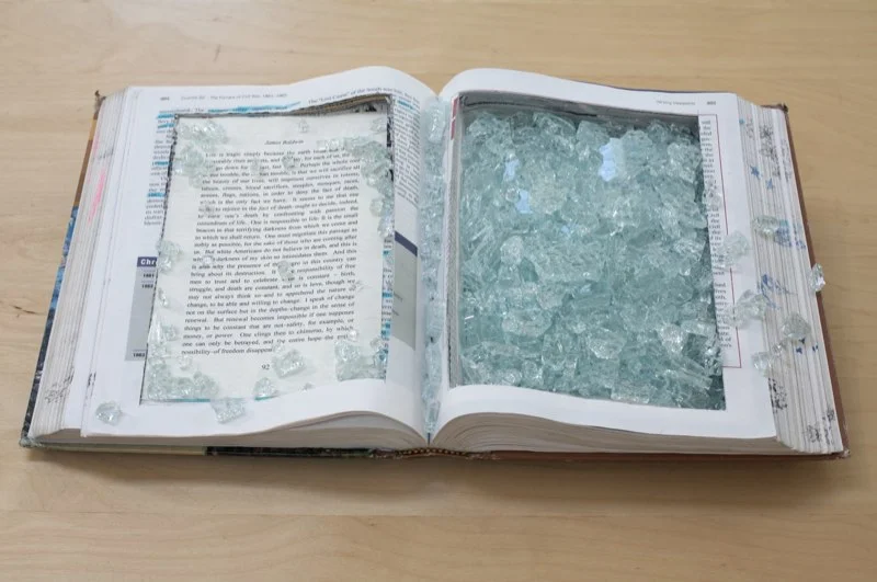 After the fire My US history textbooks, text from James Baldwin's The Fire Next Time, broken glass A meditation on a Baldwin passage that focuses on the 'drowning' mirror of whiteness, deep change and love.