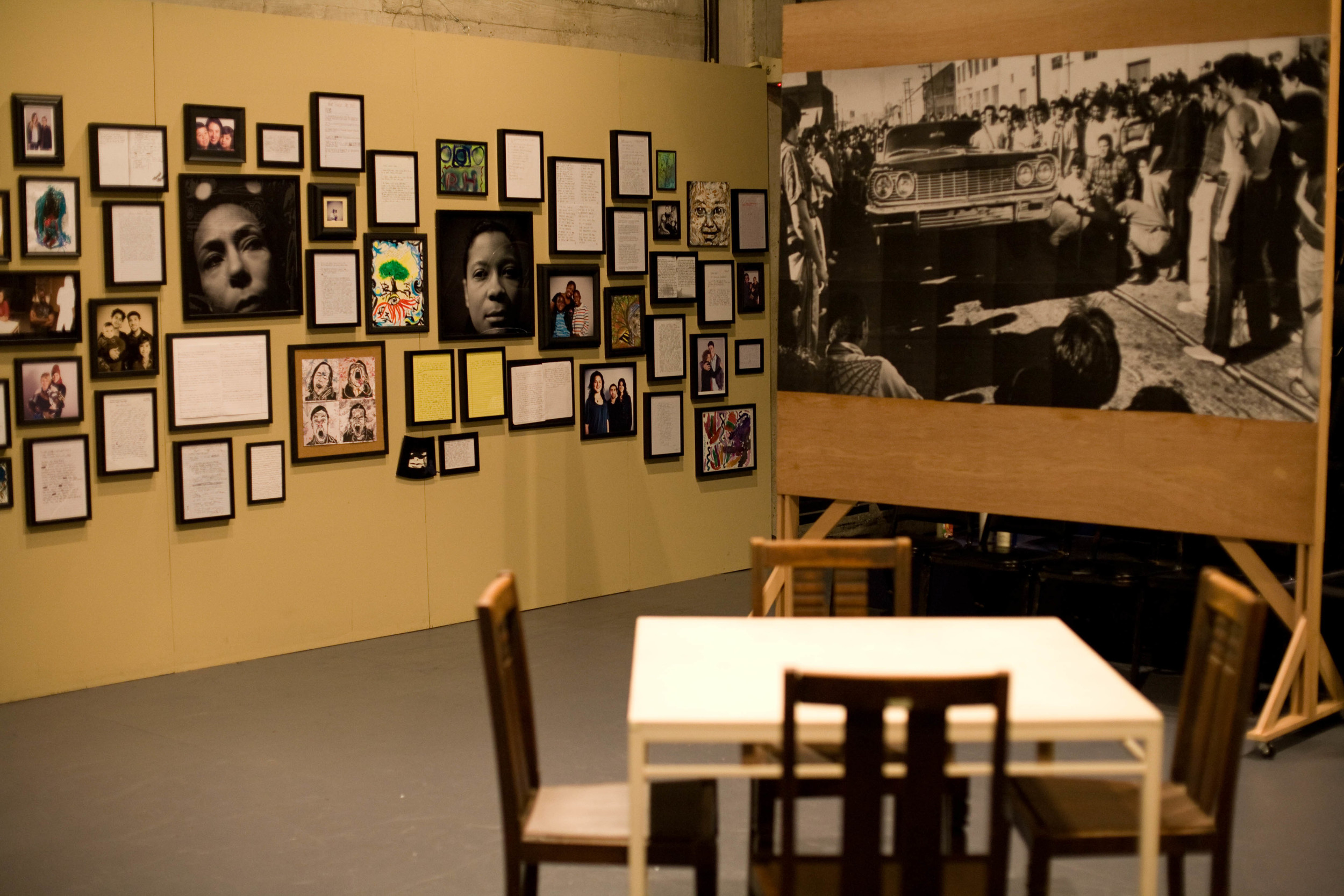 Set detail with images created by workshop participants and one half of a wheat-pasted mural depicting past and present images of the Mission district. Photo by Michael Allen Jones