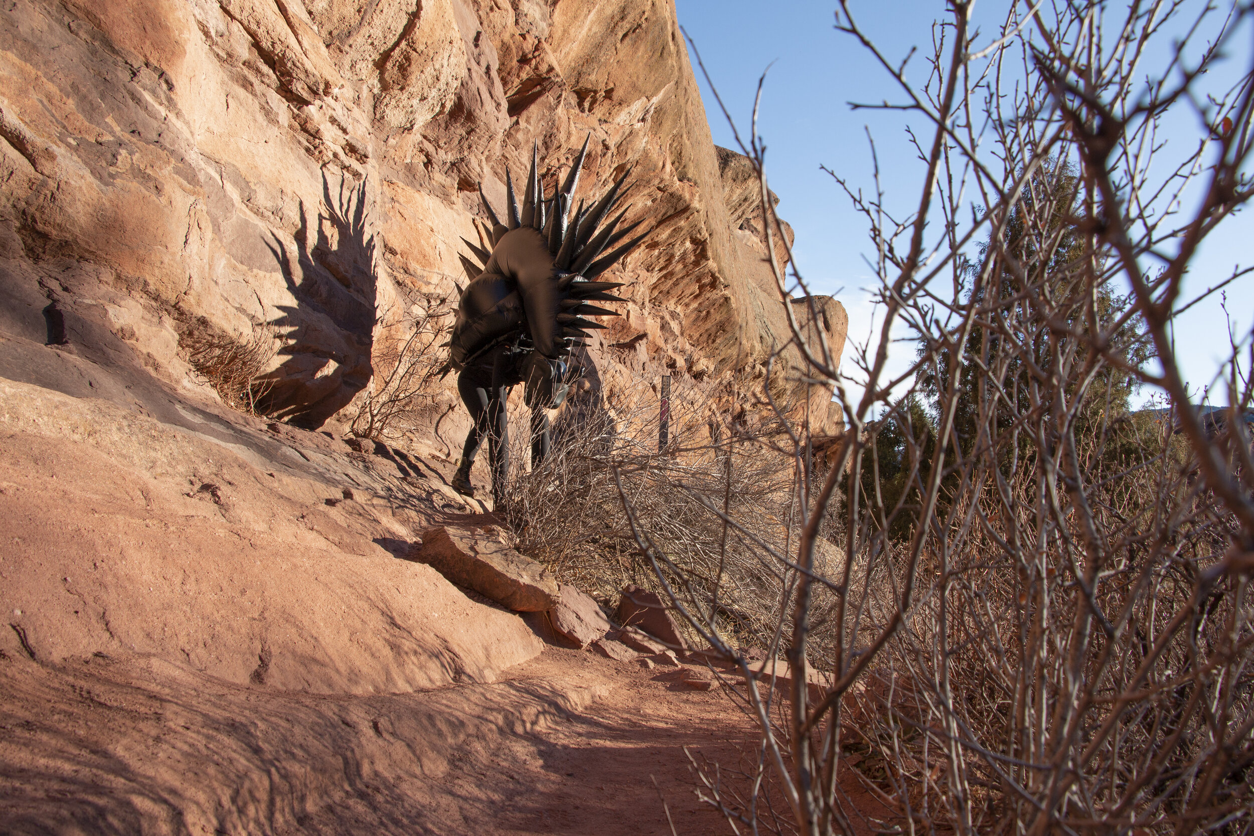 Inflatable fabric sculpture hyena beast performance in Red Rocks