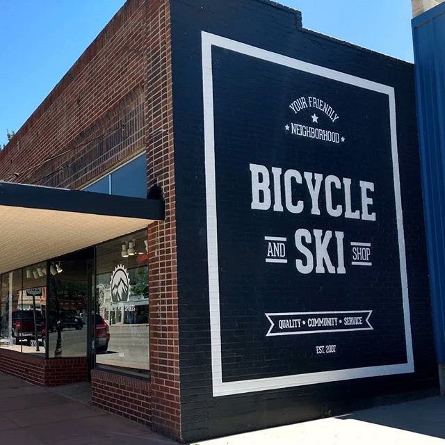 My husband and I recently renovated a historic building in downtown Lander, Wyoming for our bicycle and ski shop. We had this brick wall that had been previously painted on, so we decided to design a large sign that lets people passing by know what w