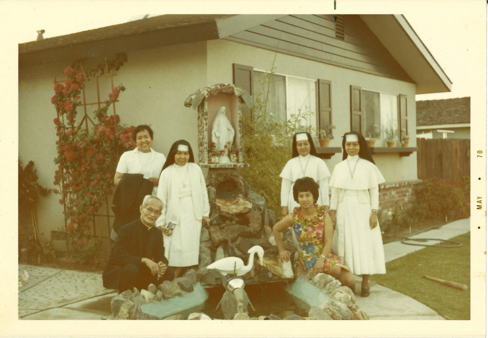 Lola with nuns and priest at the fountain. Sanger, Ca. (1970)