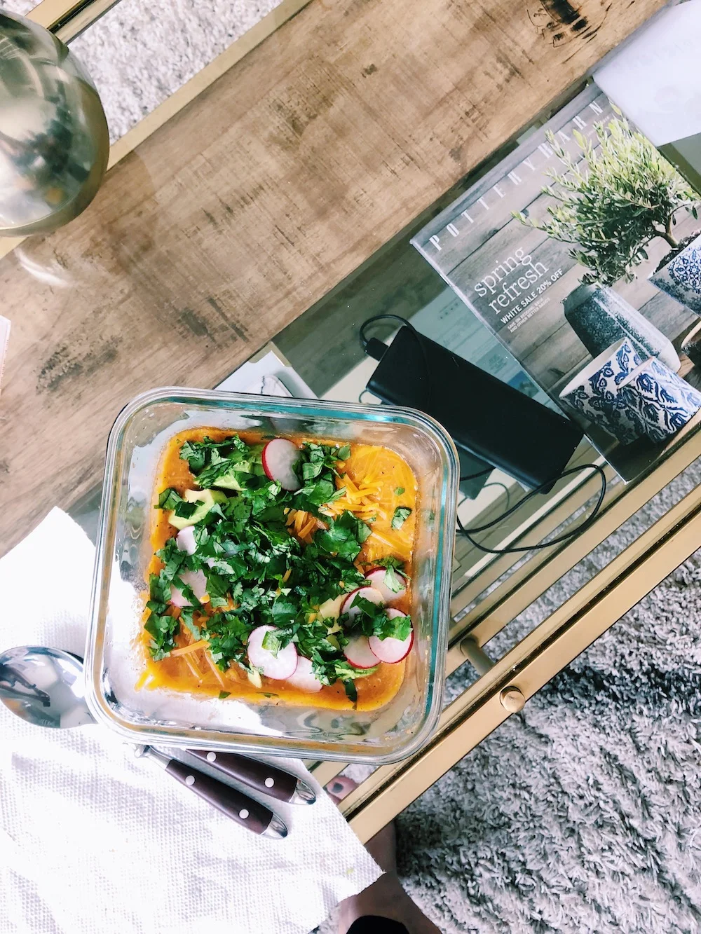 Glass of soup with cilantro and radish toppings