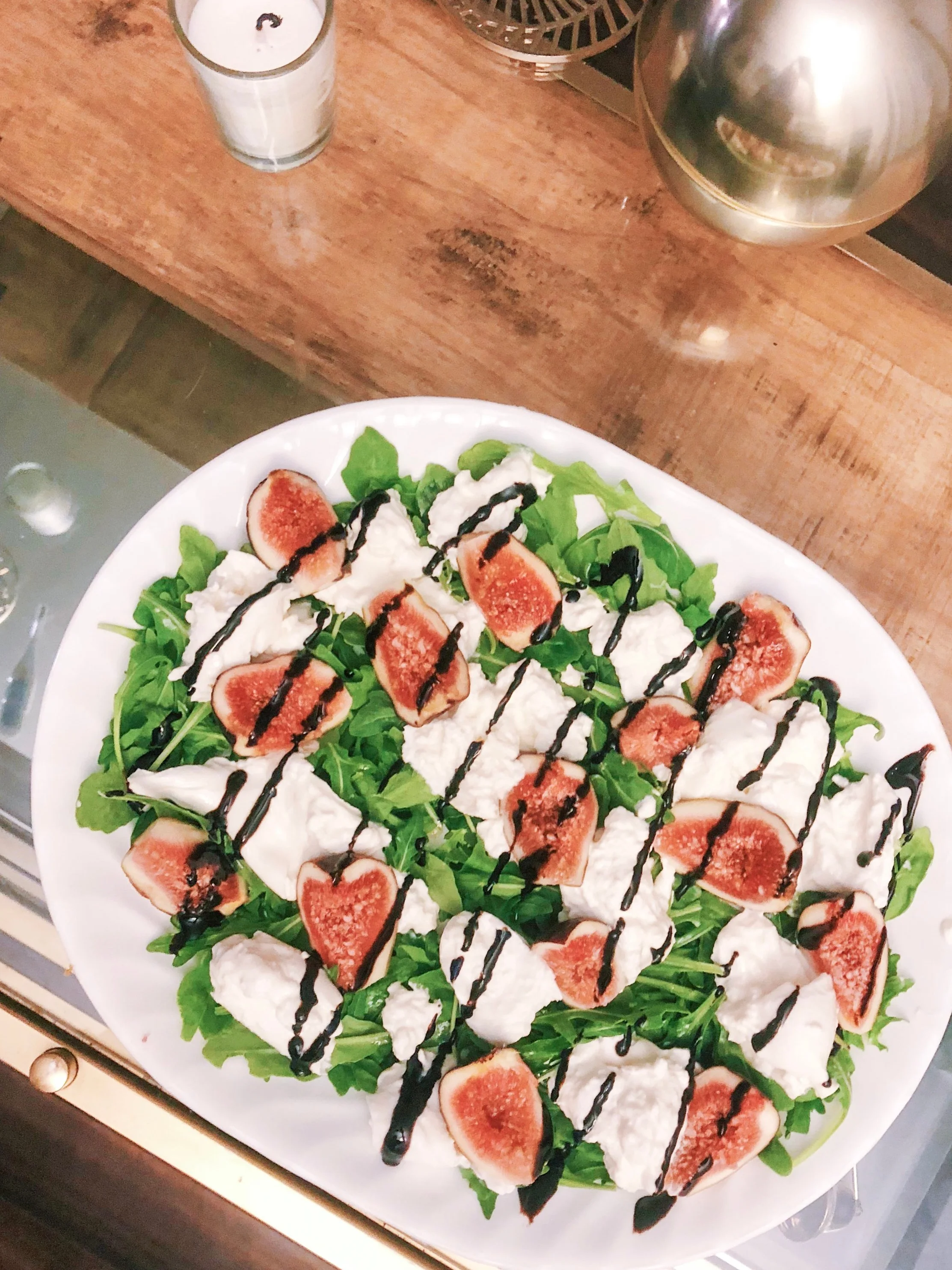 arugula salad topped with fresh figs and burrata