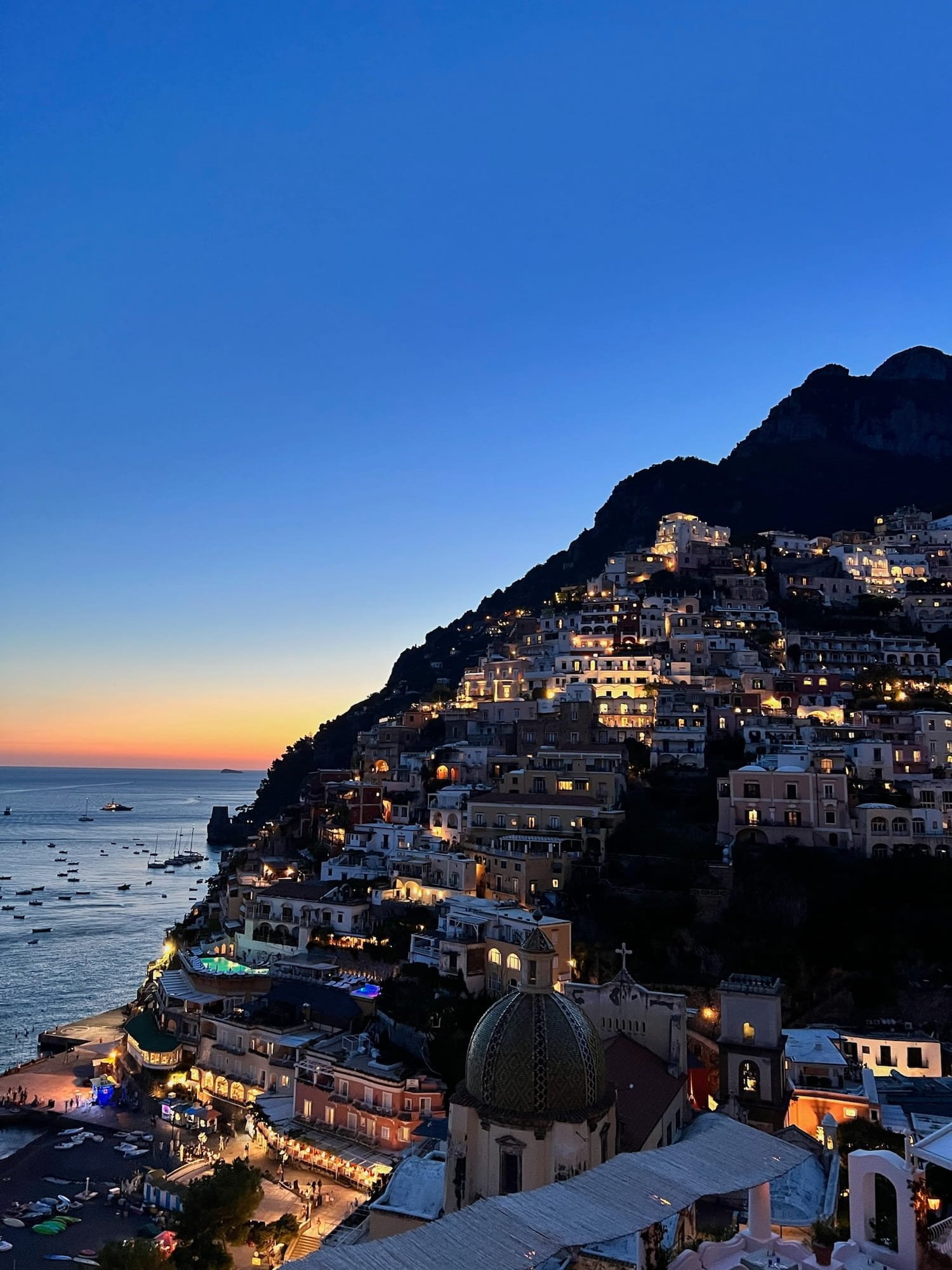 positano at dusk from terrace of franco's bar