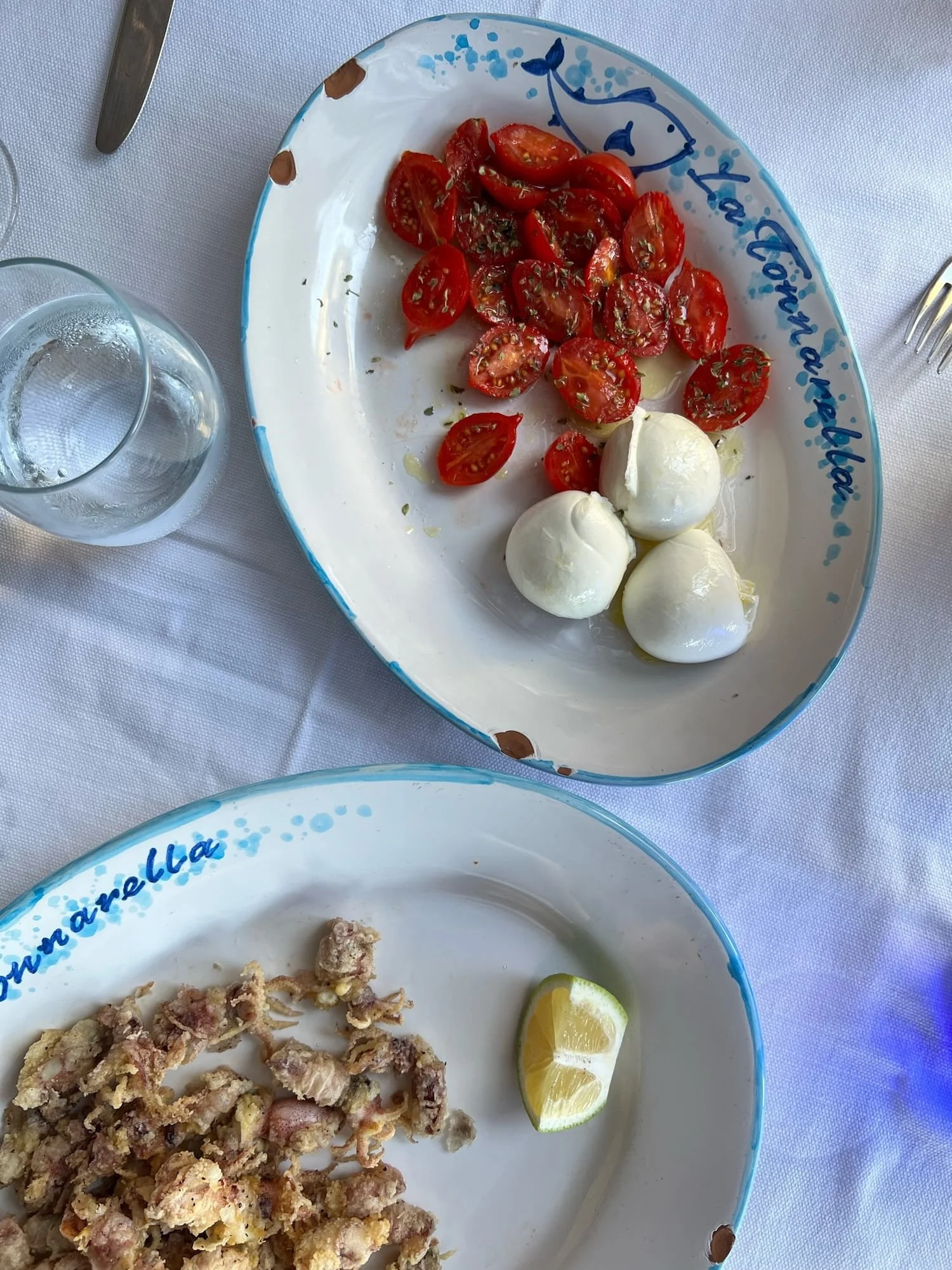 caprese and calamari on blue handpainted plates at La Tonnarella in Positano, Italy