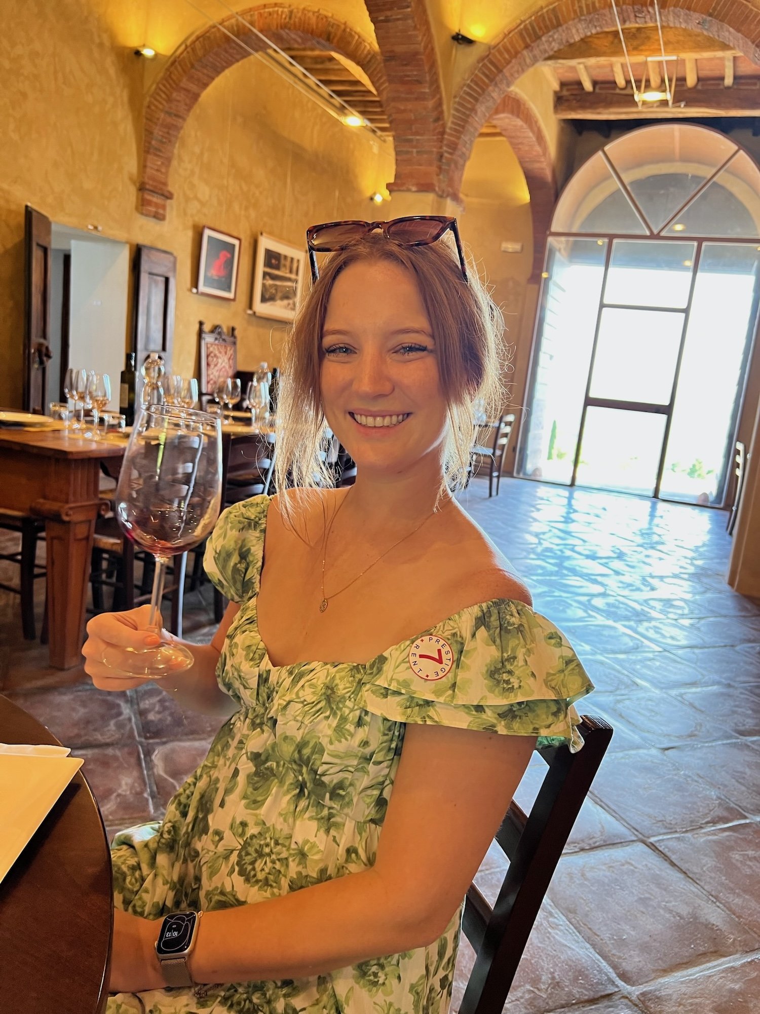 woman holding wine glass the proper way in tuscany italy