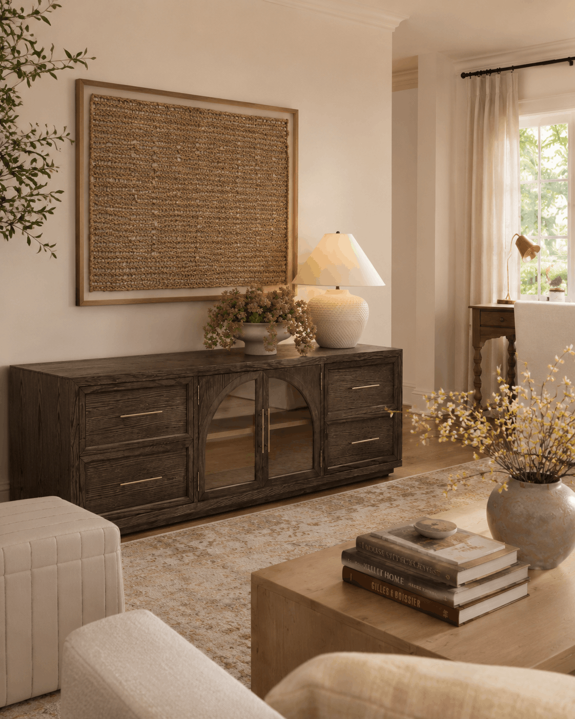 nancy meyers living room style design moodboard dark media console with light wood oak coffee table mixed wood tones