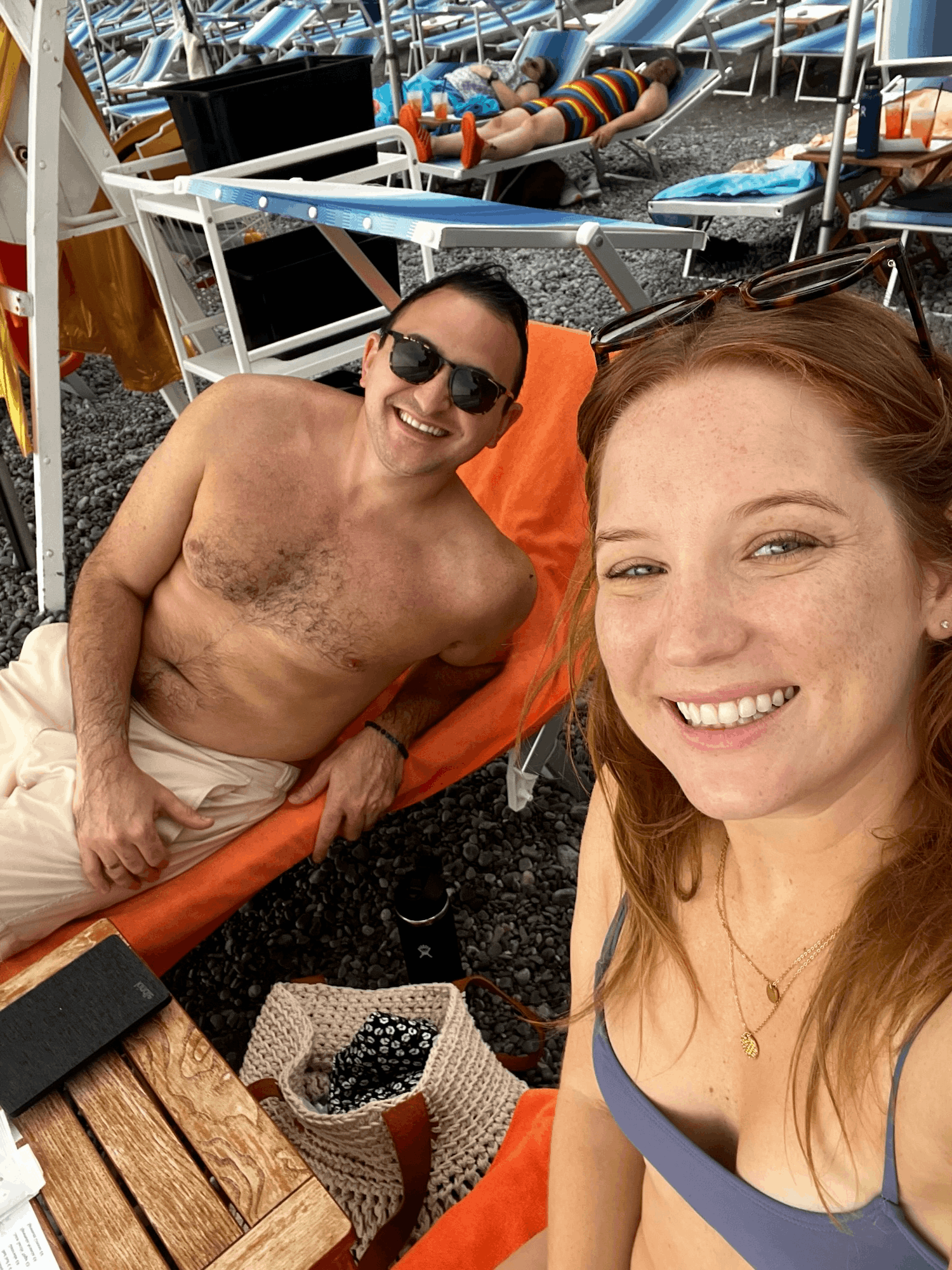 couple taking a selfie on beach chairs at hotel pupetto beach club in positano italy on amalfi coast