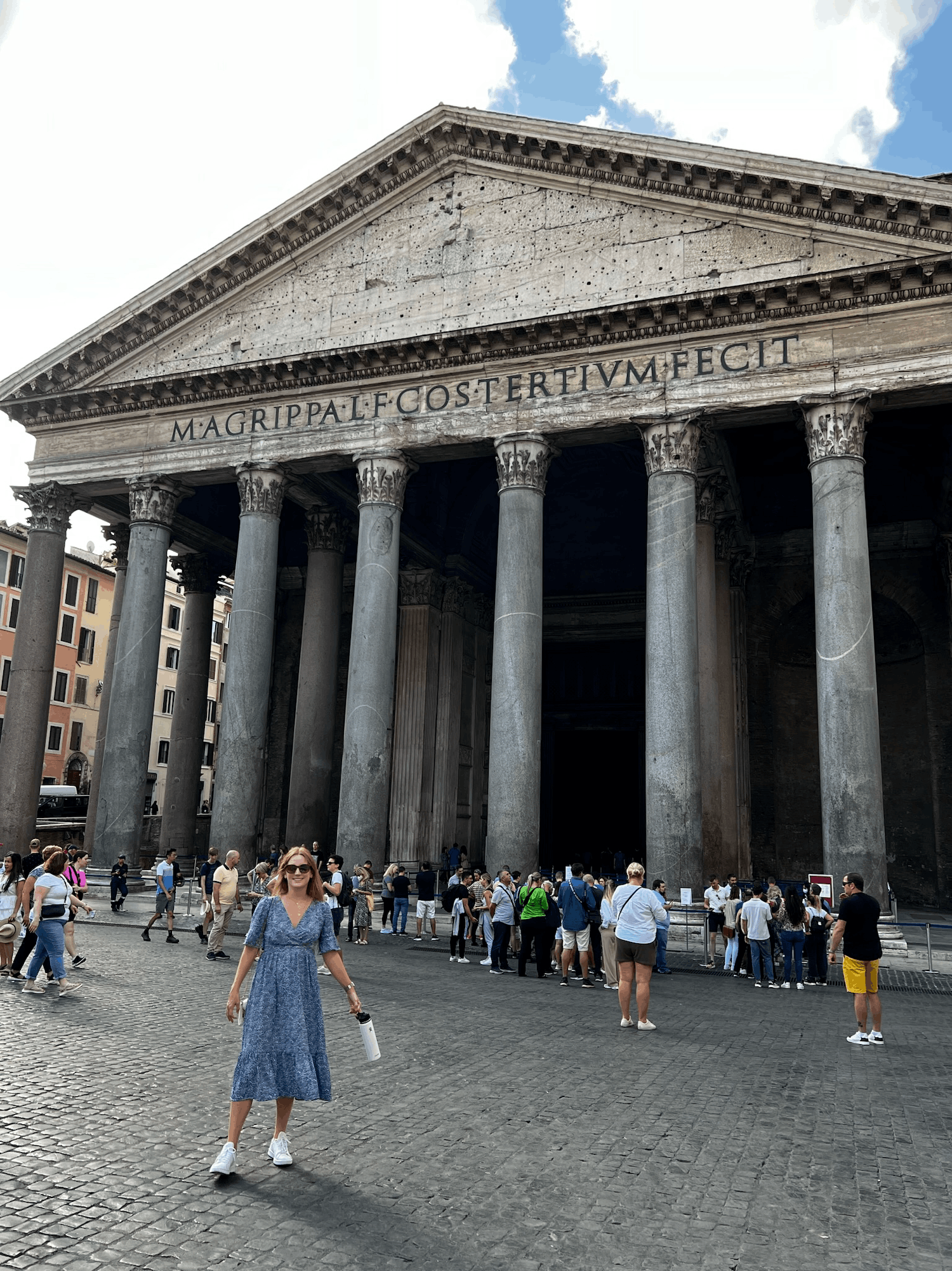 woman standing in blue dress in front of The Pantheon in Rome, Italy