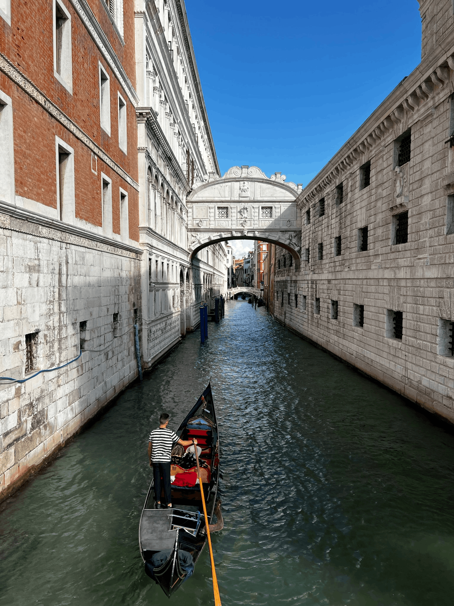 gondola floating under bridge of sighs in venice italy