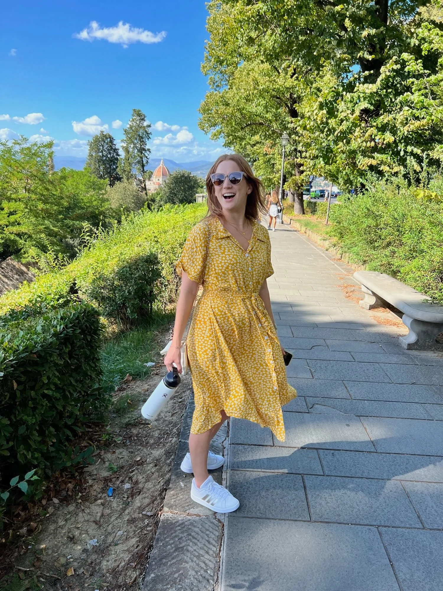 woman in yellow dress walking up to piazzale michelangelo