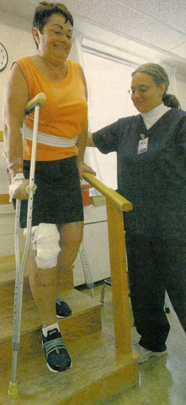 With the assistance of physical therapist Yvonne Foreman, Diana LePan was practicing walking down stairs only two days after surgery.