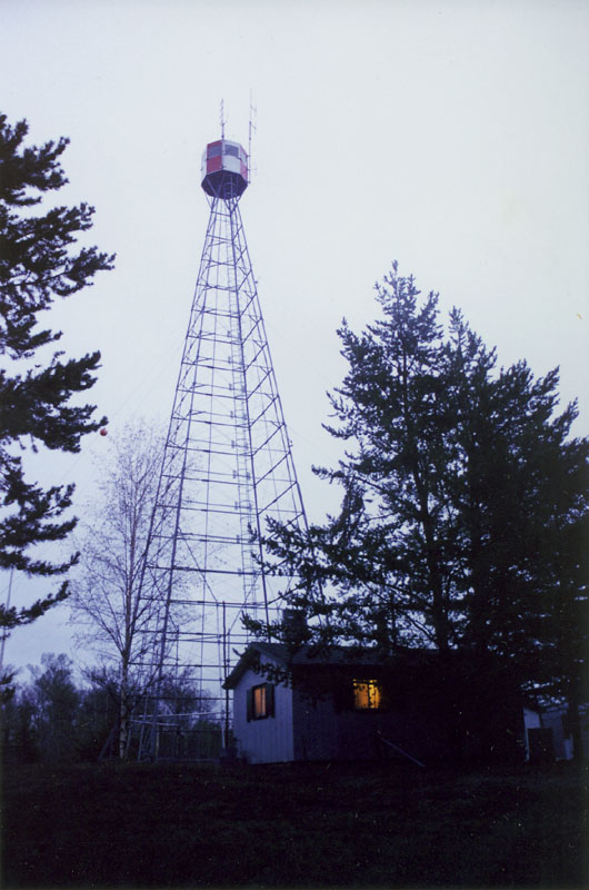 Thanks to electricity produced by a generator droning away in a nearby shed, the cabin at Chip Tower emits a warm glow as evening progresses toward night.