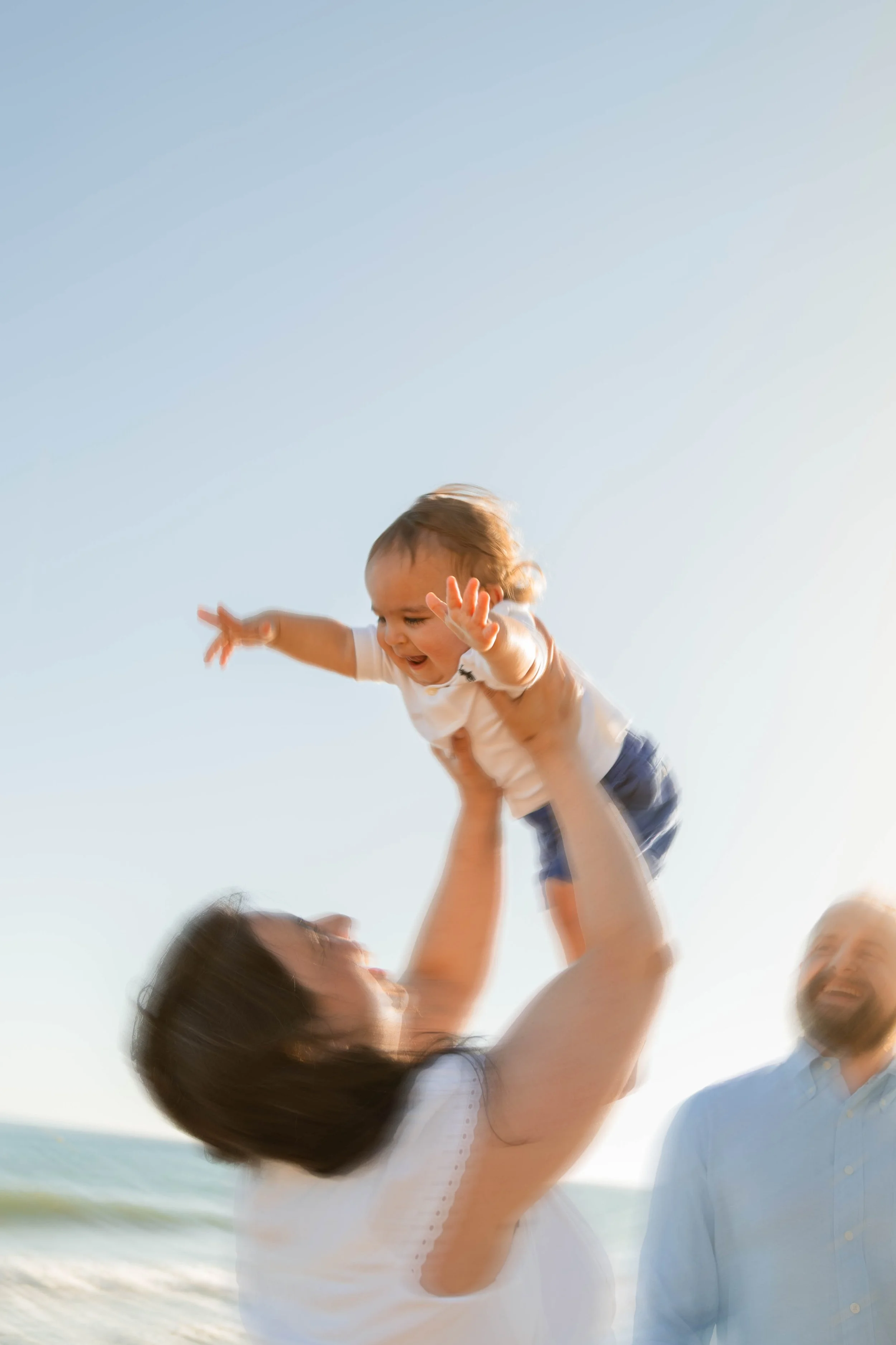 Family walking together on the beach during a natural photography session in Marbella