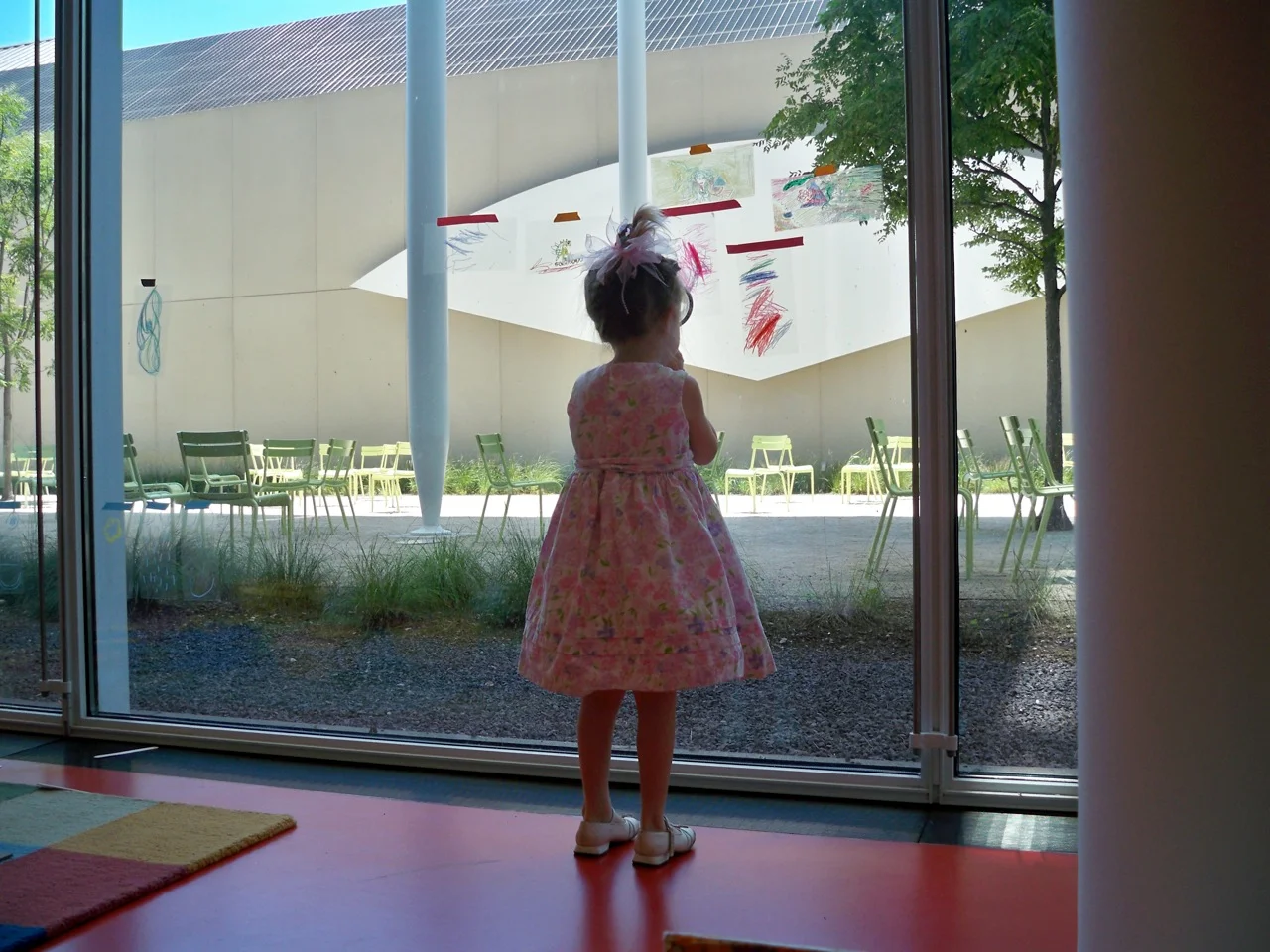 Child pondering the work of a younger child at the Art Institute of Chicago museum. Photograph by Rachel Harper.
