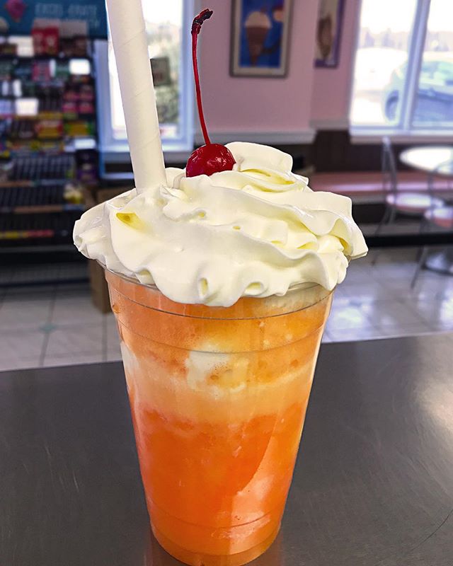 Our drink of the month is the CREAMSICLE FLOAT. Made with orange soda, vanilla ice cream, whipped cream, and a cherry on top! 🍒