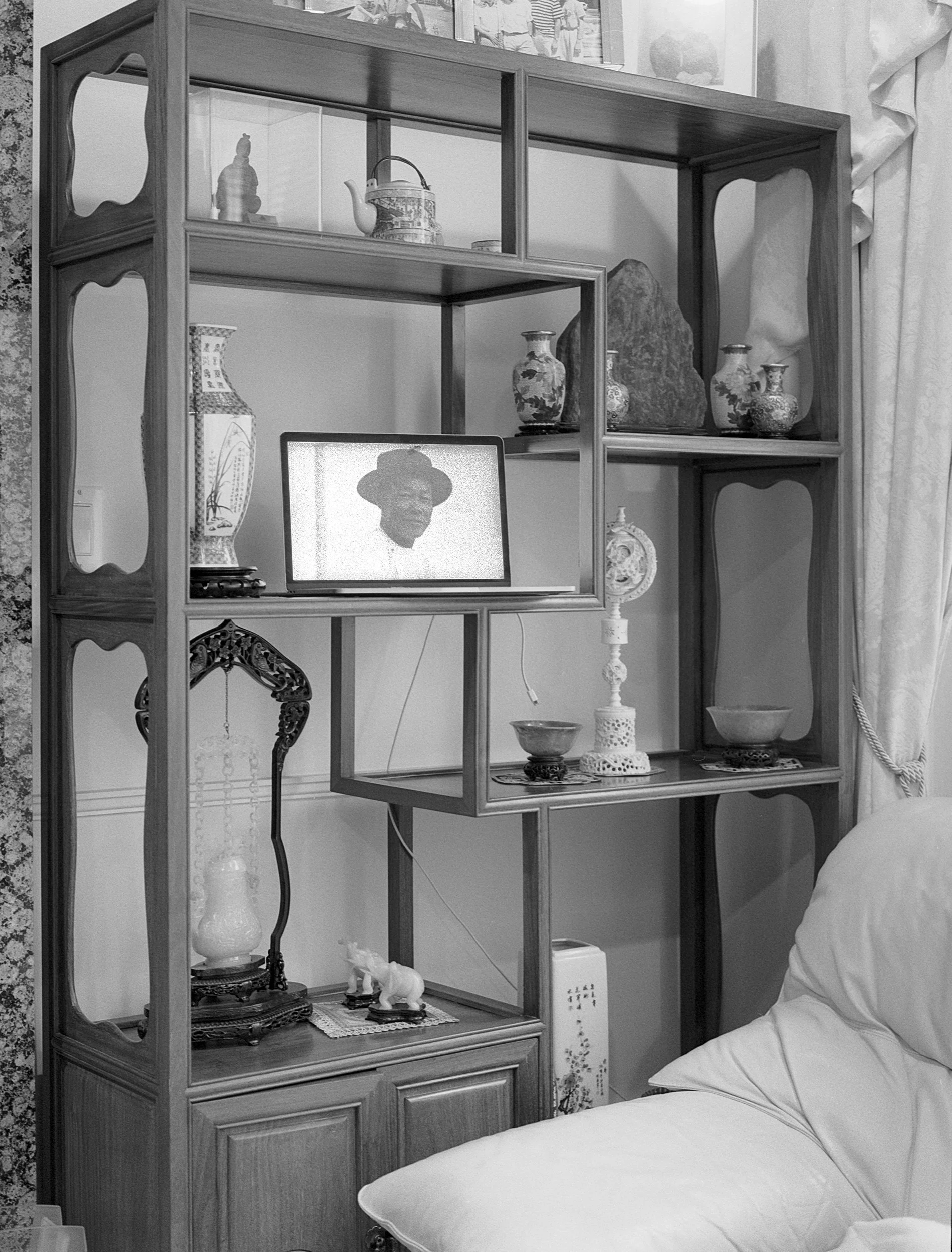 Asian house servant seated on tricycle in front of tent #2