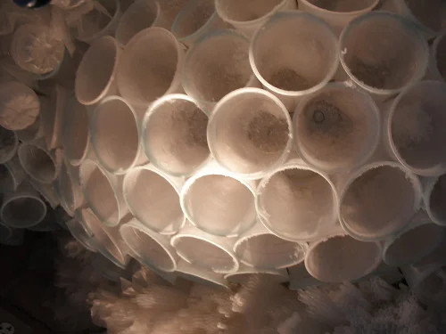  Plastic cups, dipped in blue wax and artificial snow were then attached to chicken wire and sculpted into a dome shape. 