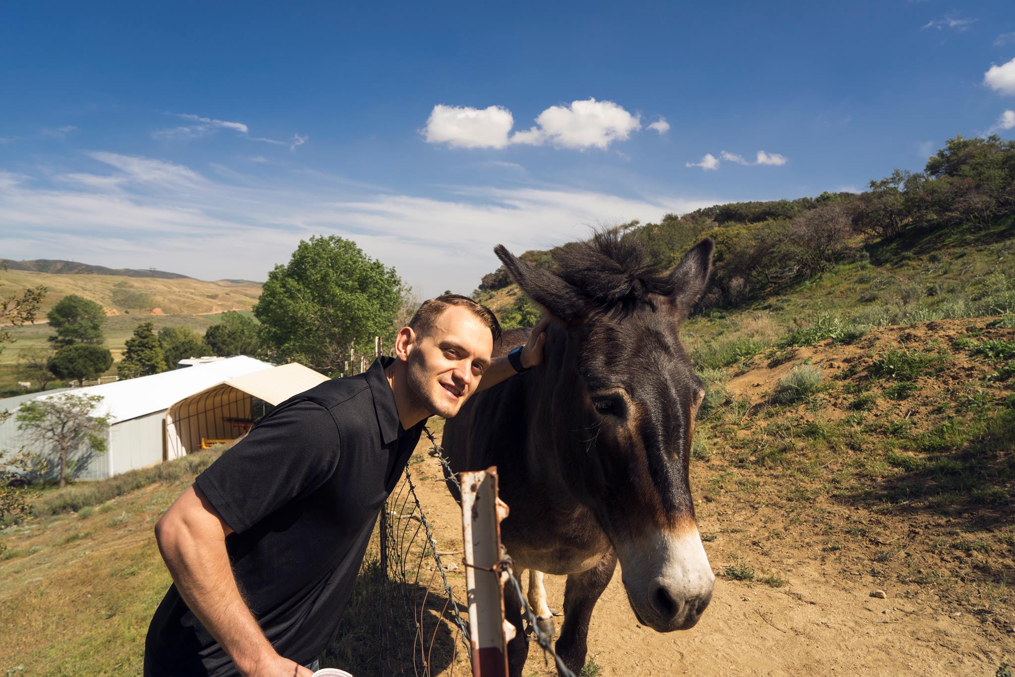 Jason's identical twin hanging with a donkey on Easter at his wife's family party
