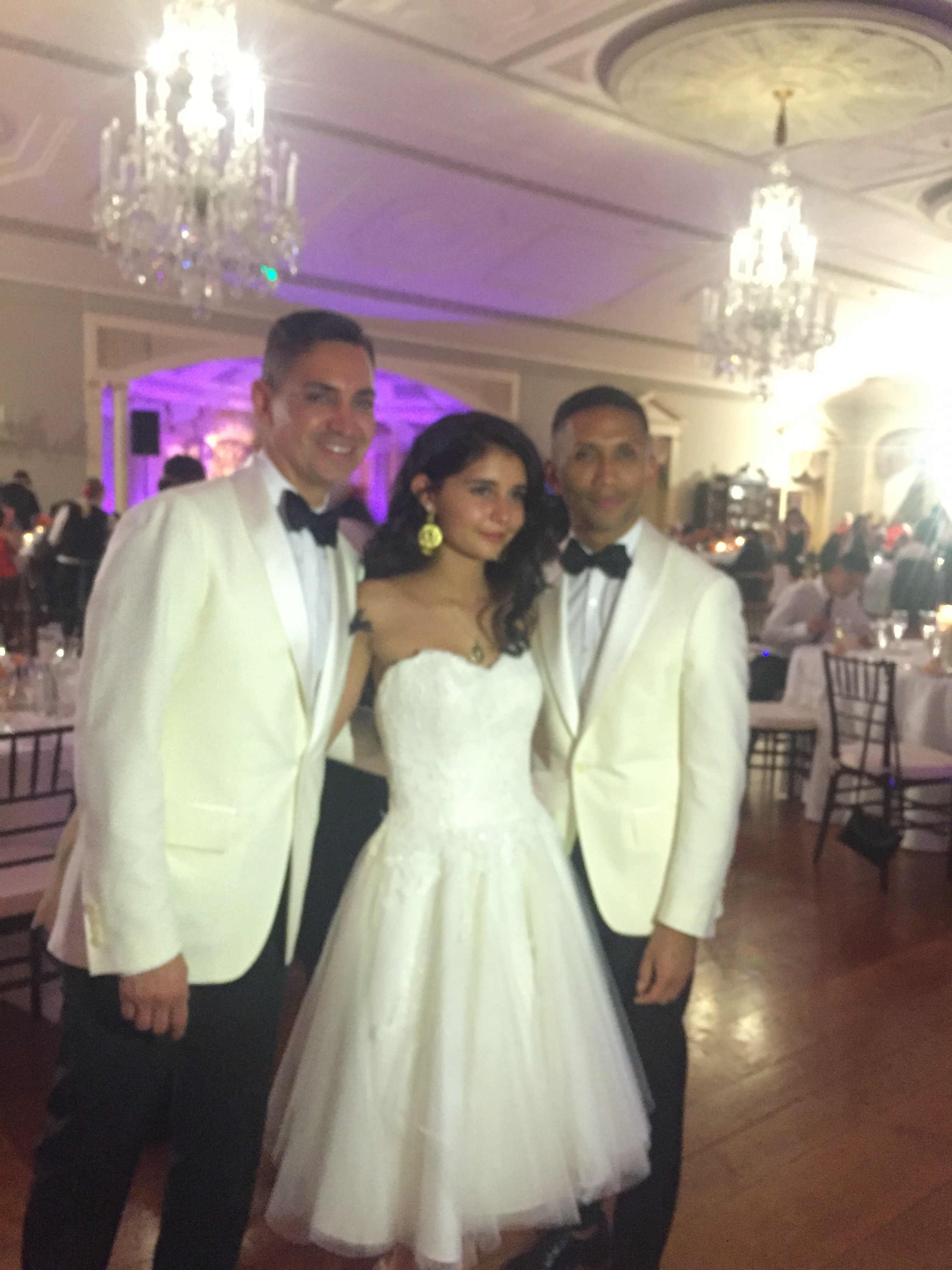 This is Paloma and her two Dad's. She had a big birthday party called a Quinceañera. It was really fancy and there was music and dancing. My mom told me this is a tradition when a Mexican girl turns 15.