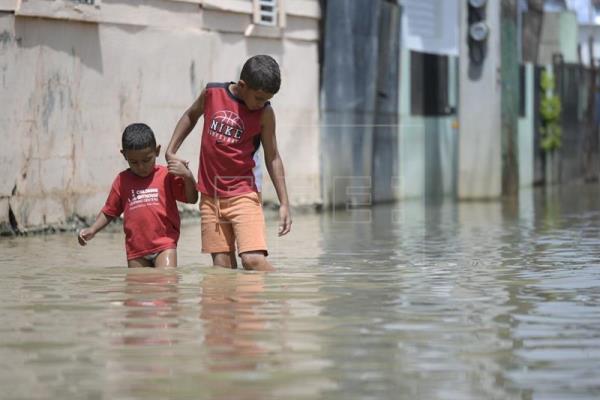 This in Dominican Republic, kids walking in knee deep water. We need your help with Anything you can give.