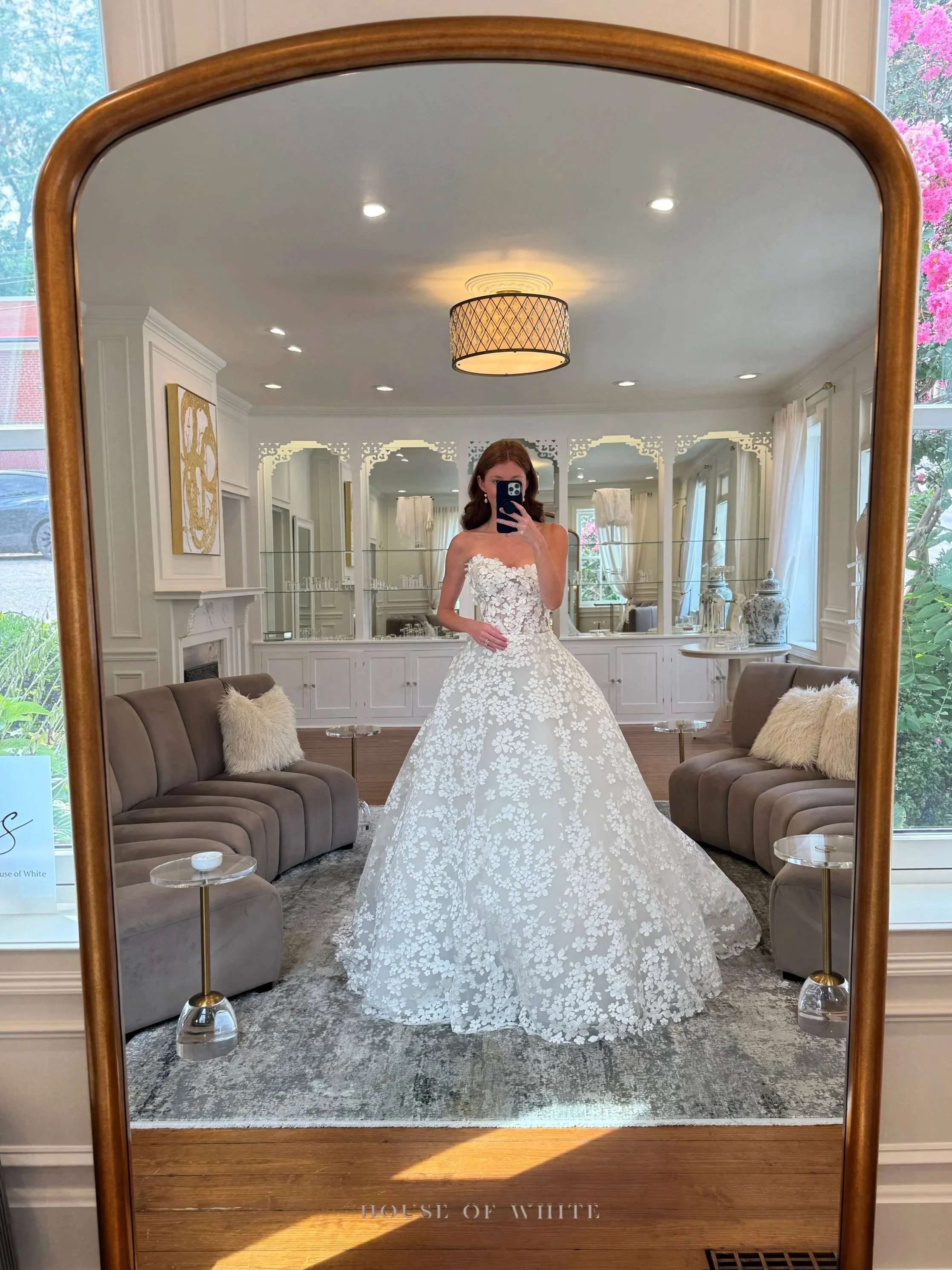 A model wears a strapless ballgown wedding dress covered with floral applique at House of White Bridal Boutique in Newburgh, Indiana
