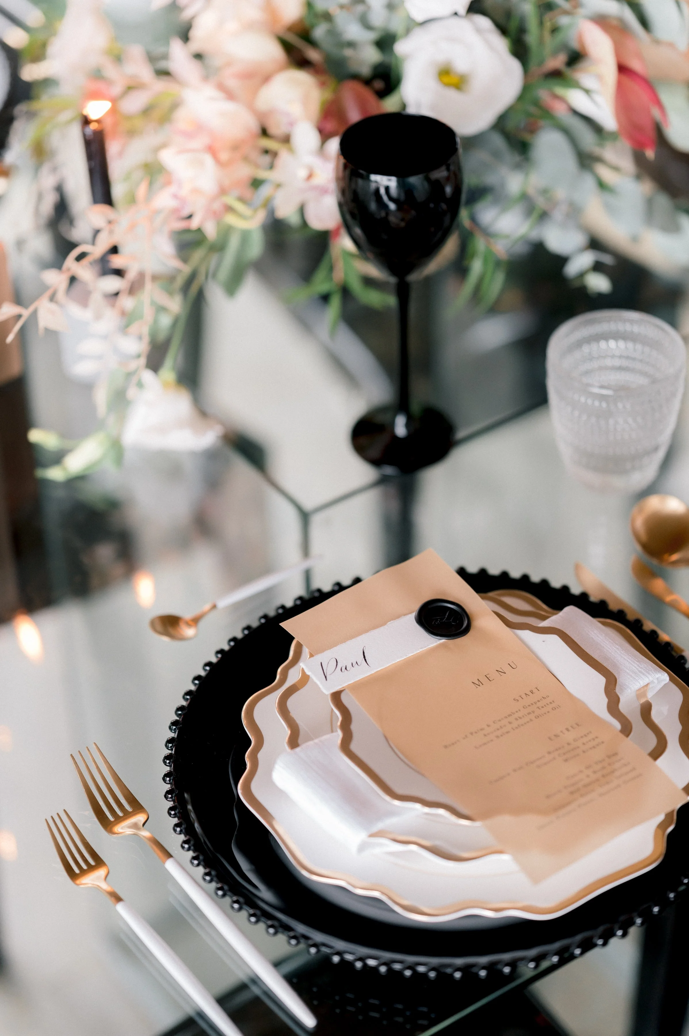 Luxe menu in gold paper , place card with hand written calligraphy attached with a gold seal