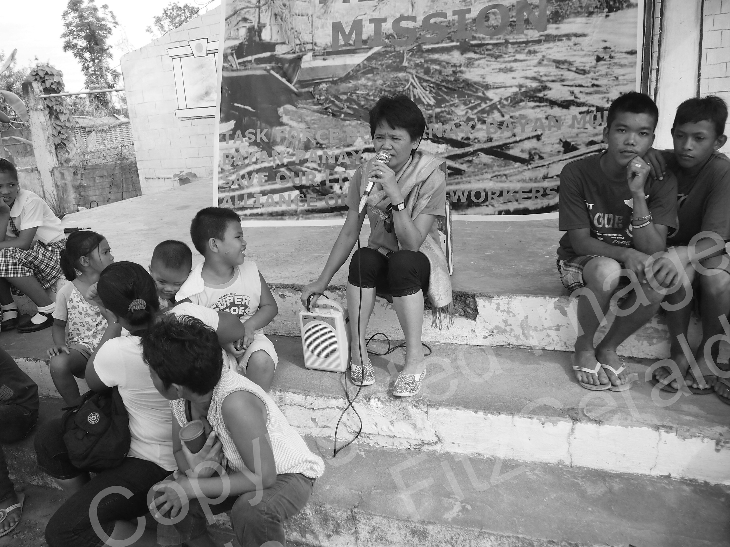  Lalay Alinsangao, from the Alliance of Healthcare Workers in the Philippines,&nbsp;takes the stage at a makeshift clinic in Estancia. The Alliance coordinated care to hundreds of people post-Haiyan. 