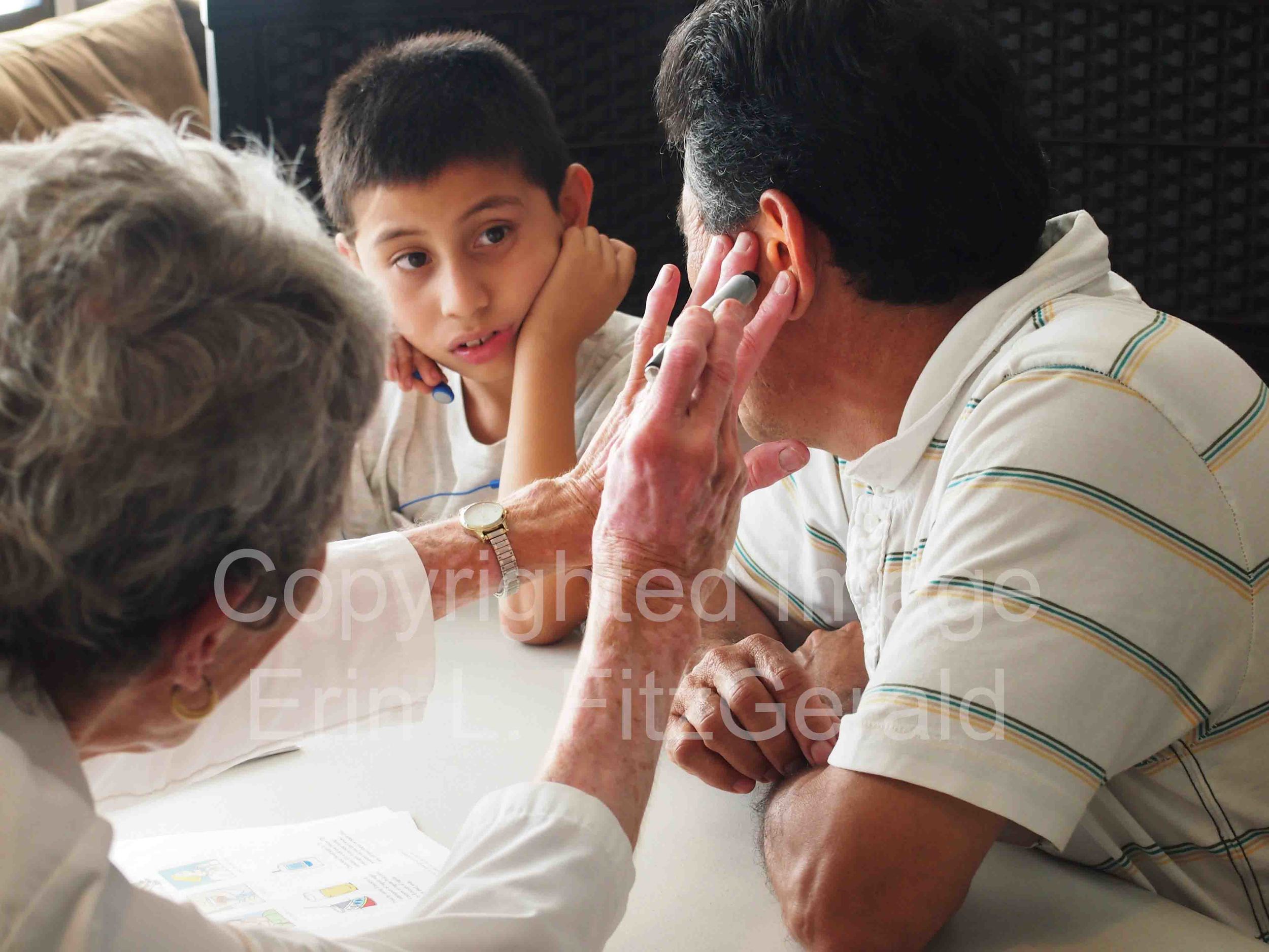   A son watches his father receive a free health screening in Santa Monica, California. The screenings were part of CNA's Medicare-for-All tour that included town hall discussions about healthcare access.  