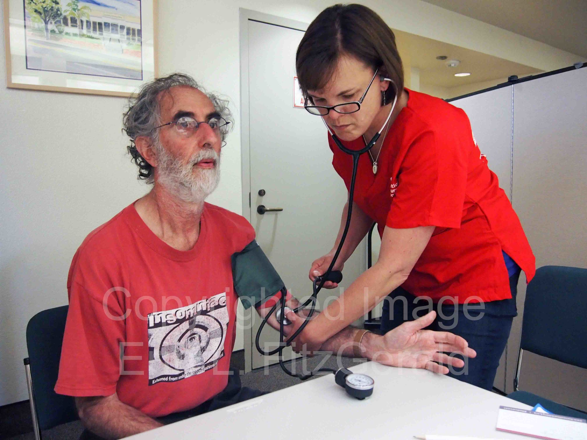  A volunteer nurse in San Luis Obispo takes a man's blood pressure during CNA's Medicare-for-All bus tour. The bus tour was designed to promote wellness, and discussion about healthcare access.  