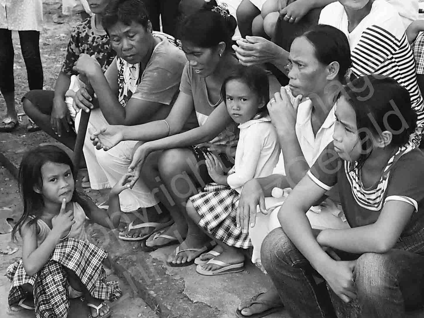   Families wait for health checkups and assistance following Typhoon Haiyan/Yolanda's onslaught in November, 2013.  